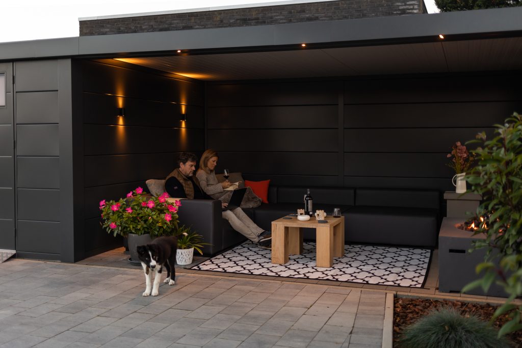 A Photo looking into the lounge with a couple and dog in the Eleganto Lounge 3330 with Extra Large Lounge in Anthracite with Optional Windows