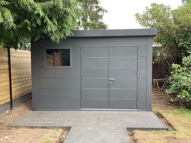 A 2nd Angled Photo in a Garden of The Eleganto 3930 Metal Steel Building in Anthracite
