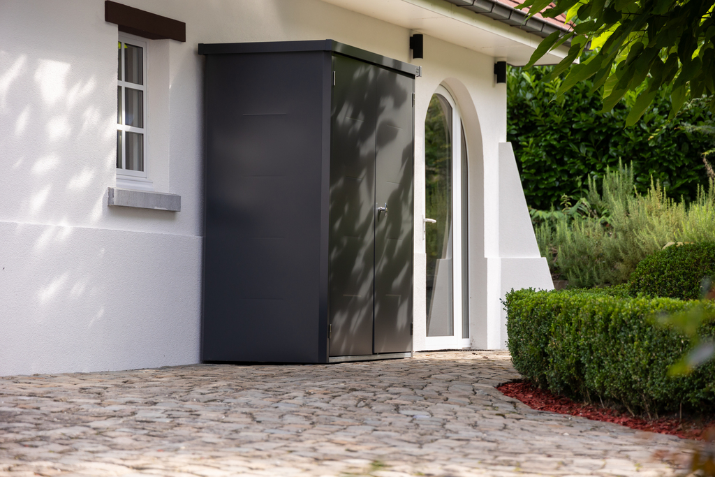 The Telluria Giamadio Garden Cupboard in Black by a house