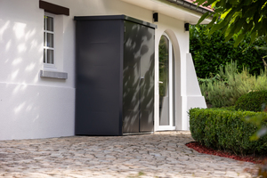 The Telluria Giamadio Garden Cupboard in Black by a house